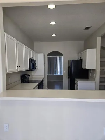 a view of a living room kitchen and a sink