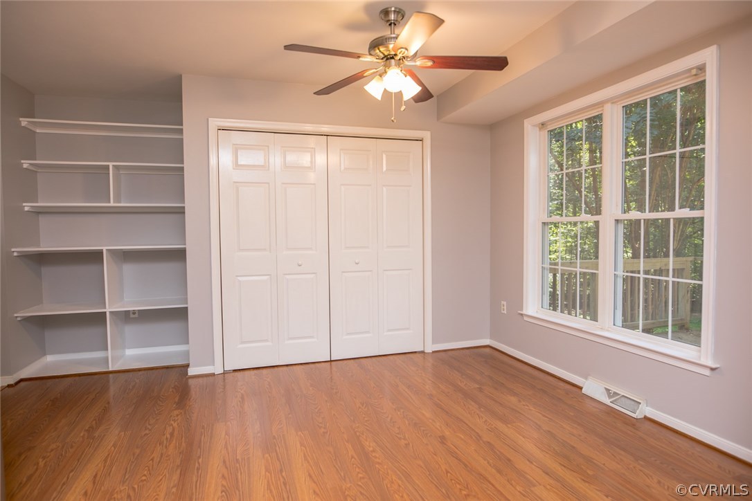 564 Jackson Road Bumpass, VA 23024 - Photo 11 of 36 a view of an empty room with a window and wooden floor