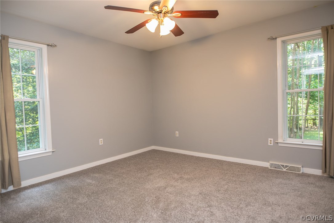 564 Jackson Road Bumpass, VA 23024 - Photo 14 of 36 an empty room with a window and a fan