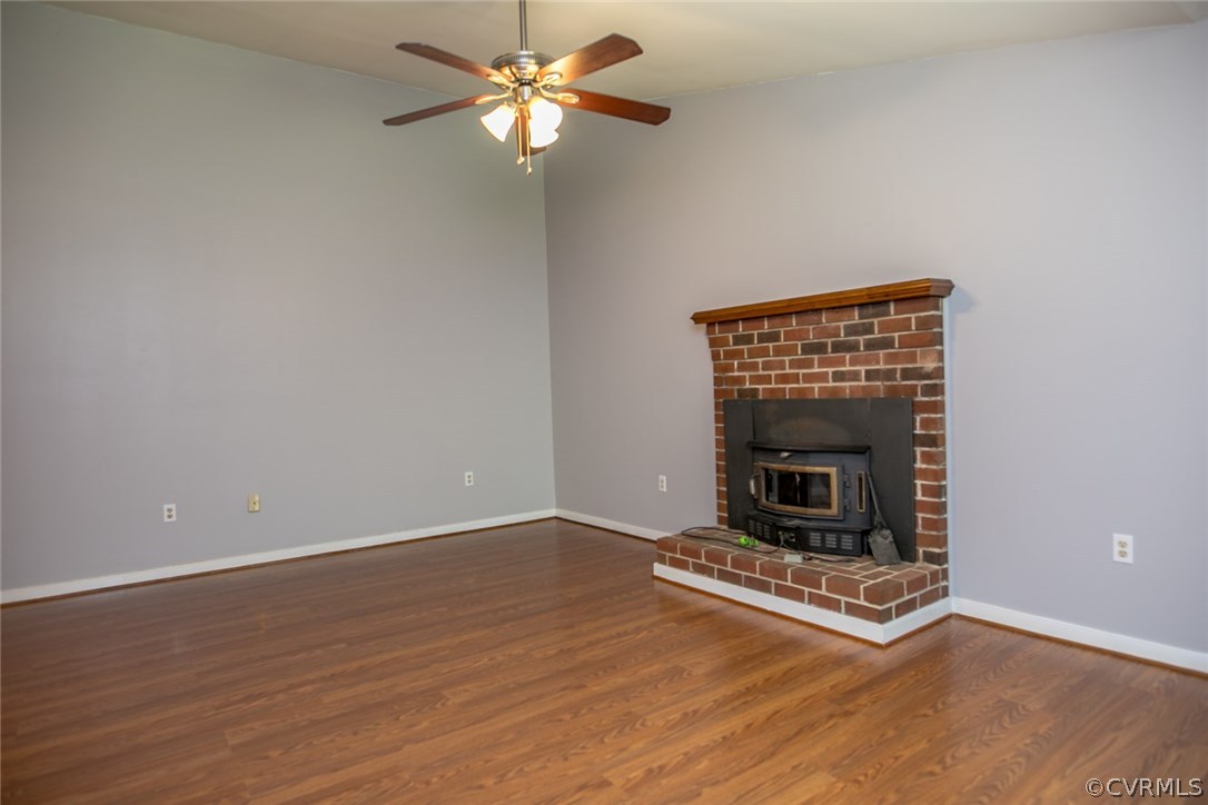 564 Jackson Road Bumpass, VA 23024 - Photo 3 of 36 an empty room with a fireplace and fan