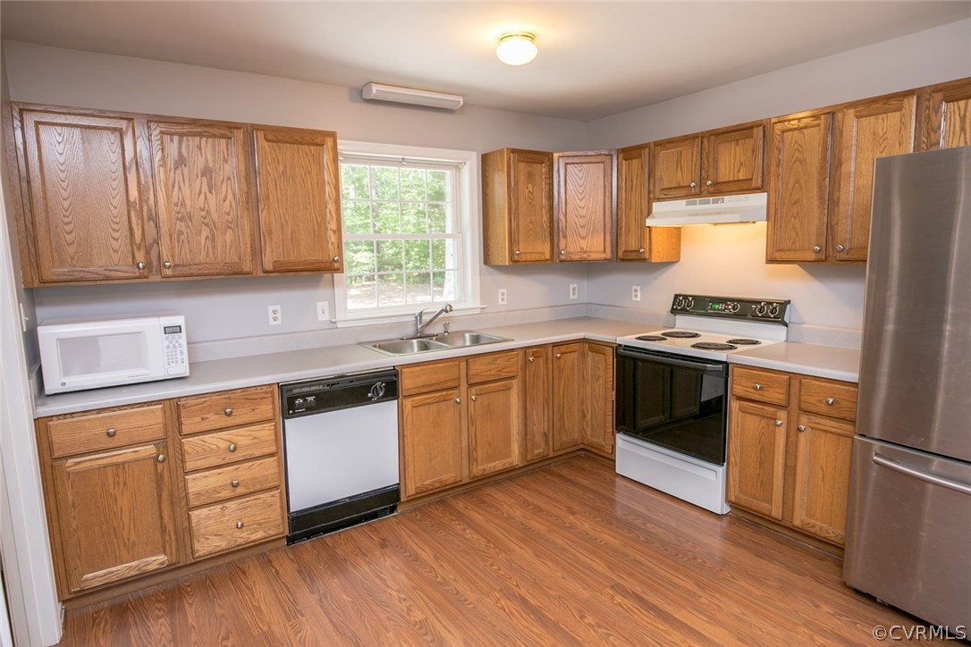 564 Jackson Road Bumpass, VA 23024 - Photo 5 of 36 a kitchen with stainless steel appliances granite countertop white cabinets a sink a stove a refrigerator with wooden floors and cabinets