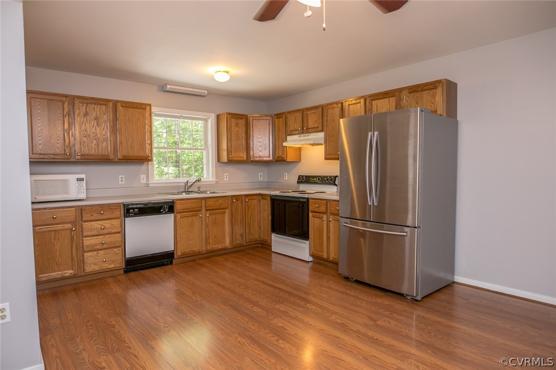 564 Jackson Road Bumpass, VA 23024 - Photo 7 of 36 a kitchen with granite countertop wooden floors stainless steel appliances and sink