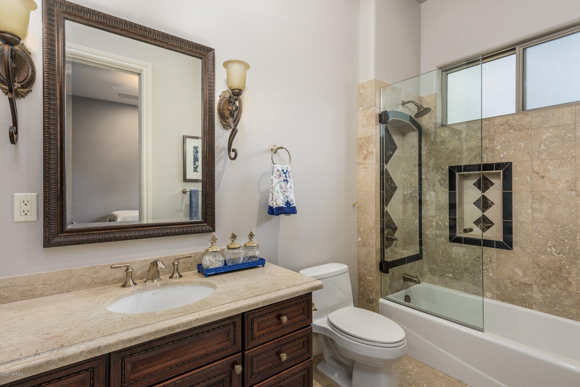 307 West Lamar Road Phoenix, AZ 85013 - Photo 34 of 61 a bathroom with a granite countertop toilet a sink and a mirror