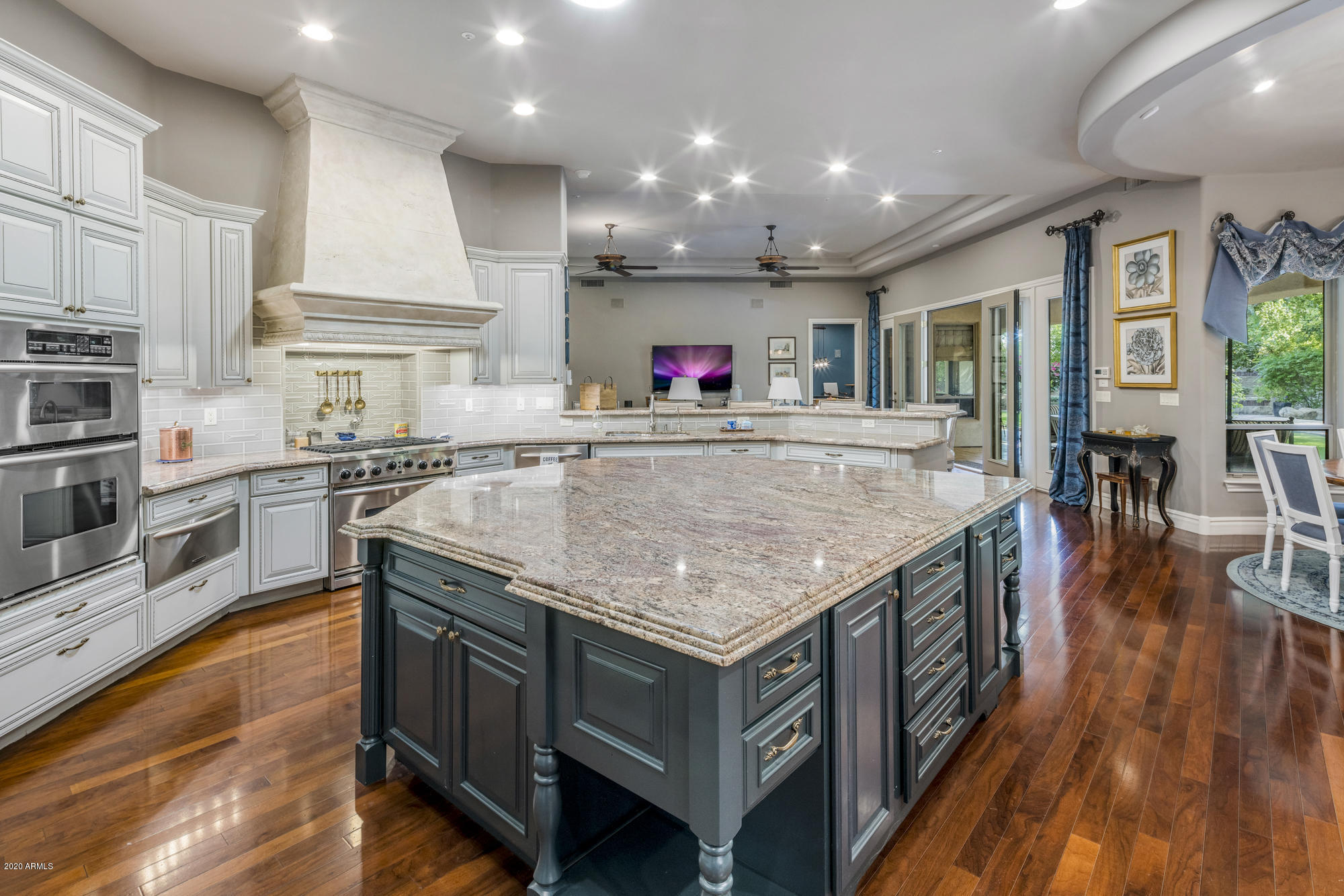 307 West Lamar Road Phoenix, AZ 85013 - Photo 6 of 61 a kitchen with stainless steel appliances granite countertop a stove and a wooden floors