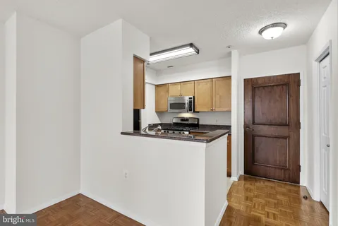a kitchen with stainless steel appliances granite countertop a stove and a refrigerator