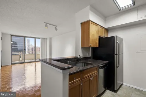 a kitchen with a refrigerator and a sink
