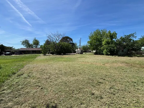 a view of a garden with a building in the background