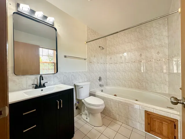 a bathroom with a toilet a bath tub and a shower