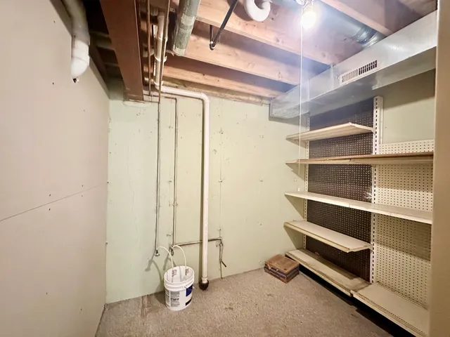 a view of a white house with a big yard and large trees