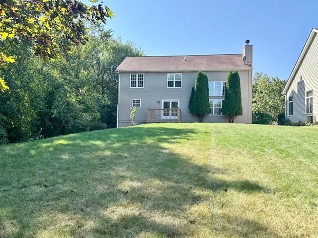 a view of a house with backyard and wooden floor