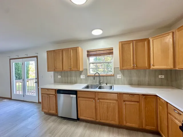 a kitchen with sink cabinets and wooden floor