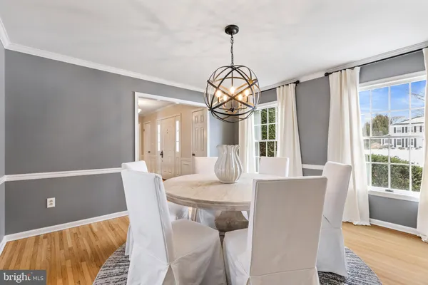 a view of a dining room with furniture wooden floor and chandelier