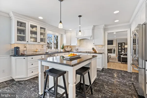 a kitchen with stainless steel appliances granite countertop a stove refrigerator and cabinets