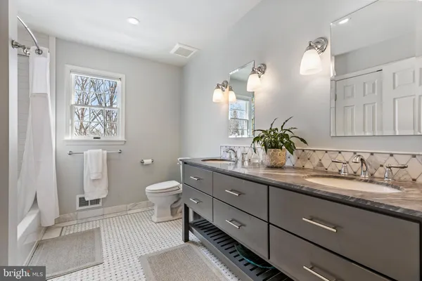 a bathroom with a toilet a sink and mirror