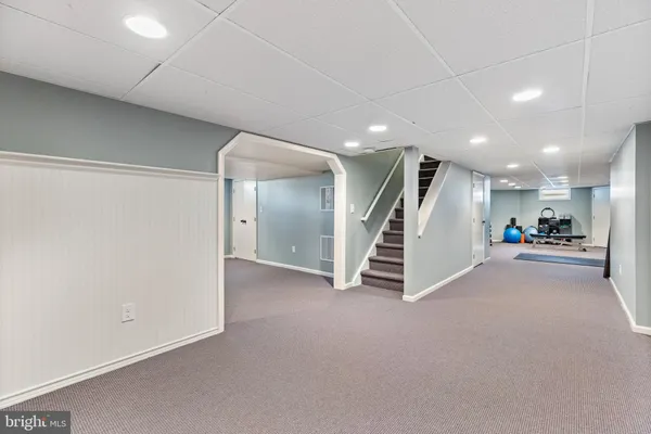 a view of a big room with wooden floor and a ceiling fan