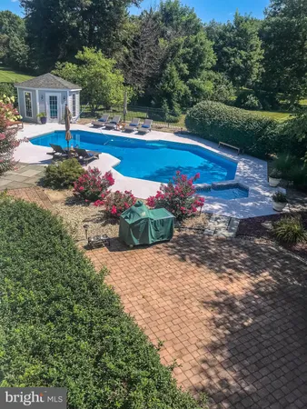 a view of backyard with swimming pool and outdoor seating
