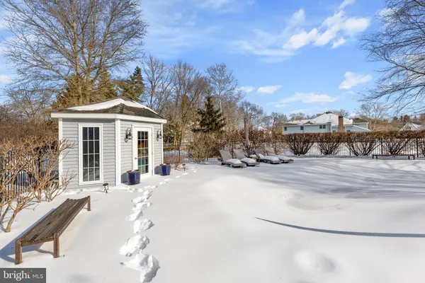 a view of a house with snow on the road