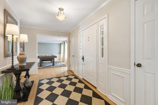 a walk in closet with wooden floor