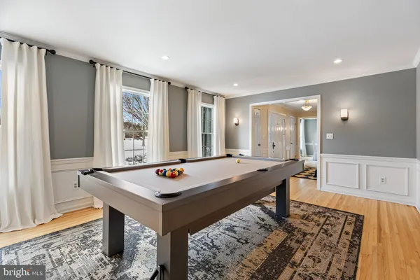 a room with pool table and windows