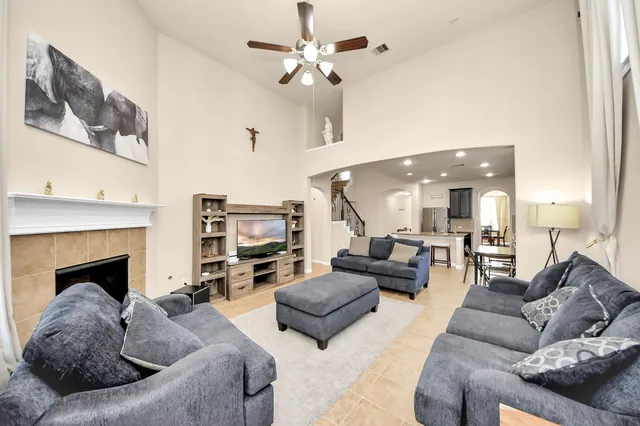 a living room with furniture fireplace and a chandelier