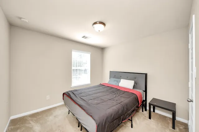 a bedroom with a bed and a window