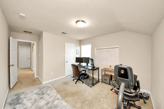 a spacious bedroom with a bed and a window