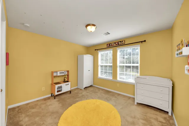 a view of a house with backyard and porch