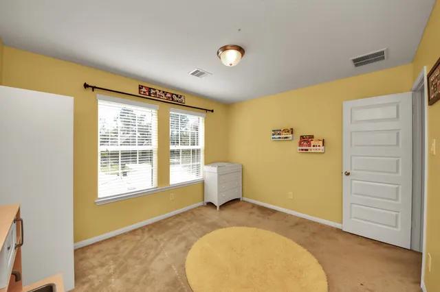 a view of a house with brick walls