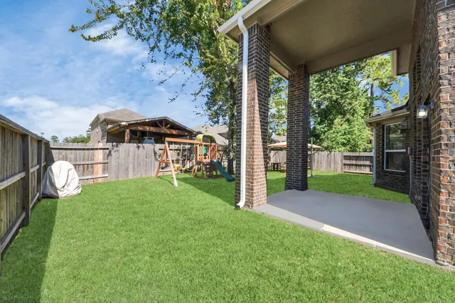 a view of a house with a backyard and a slide