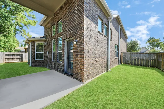 a backyard of a house with table and chairs