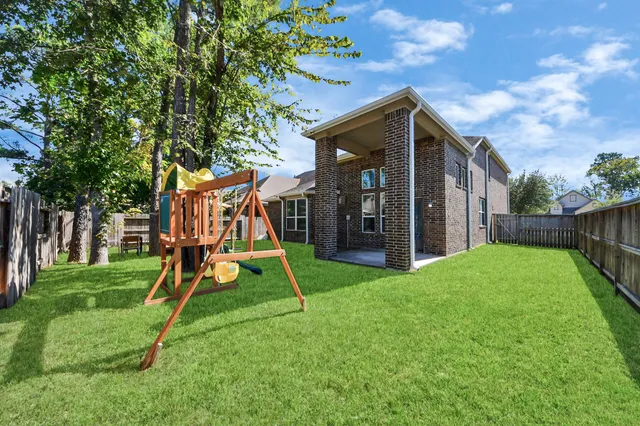 a view of yard with swimming pool and furniture