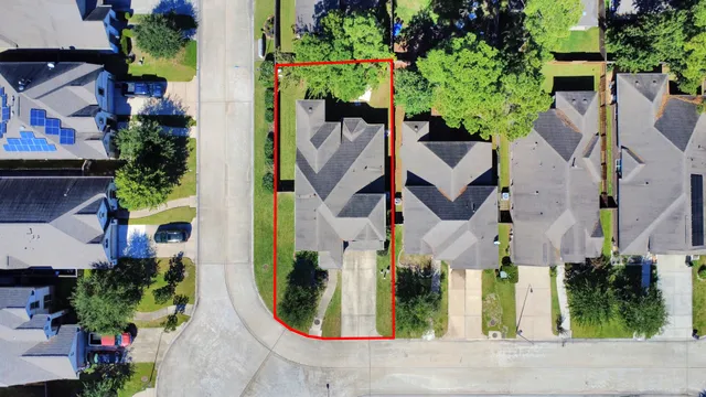 an aerial view of residential houses with outdoor space