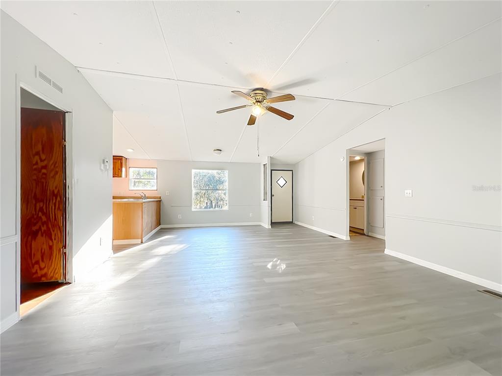 790 South Ebenezer Point Homosassa, FL 34448 - Photo 11 of 46 an empty room with chandelier fan and windows