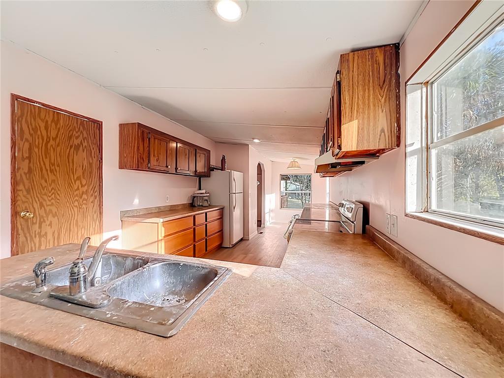 790 South Ebenezer Point Homosassa, FL 34448 - Photo 13 of 46 a kitchen with stainless steel appliances granite countertop a sink and a window