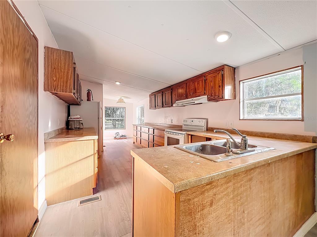 790 South Ebenezer Point Homosassa, FL 34448 - Photo 14 of 46 a kitchen that has a sink a stove and a refrigerator