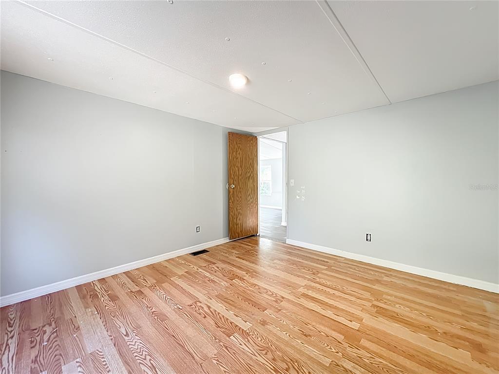 790 South Ebenezer Point Homosassa, FL 34448 - Photo 23 of 46 a view of an empty room with wooden floor