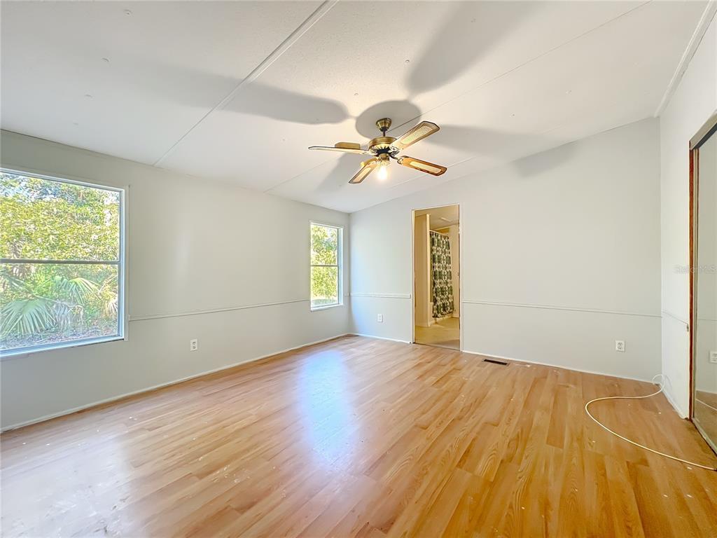 790 South Ebenezer Point Homosassa, FL 34448 - Photo 27 of 46 a view of an empty room with a window and wooden floor
