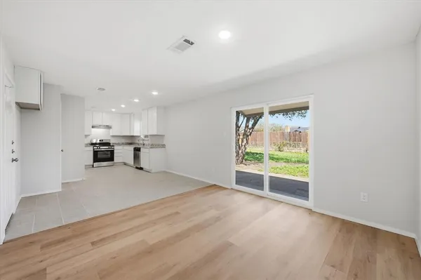 a view of kitchen with wooden floor and electronic appliances
