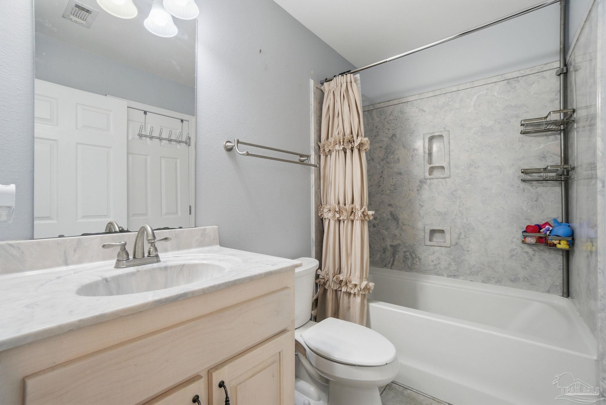 4393 Rice Road Milton, FL 32583 - Photo 15 of 52 a bathroom with a sink toilet vanity and shower