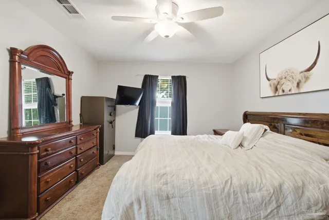 a bedroom with a bed and a dresser