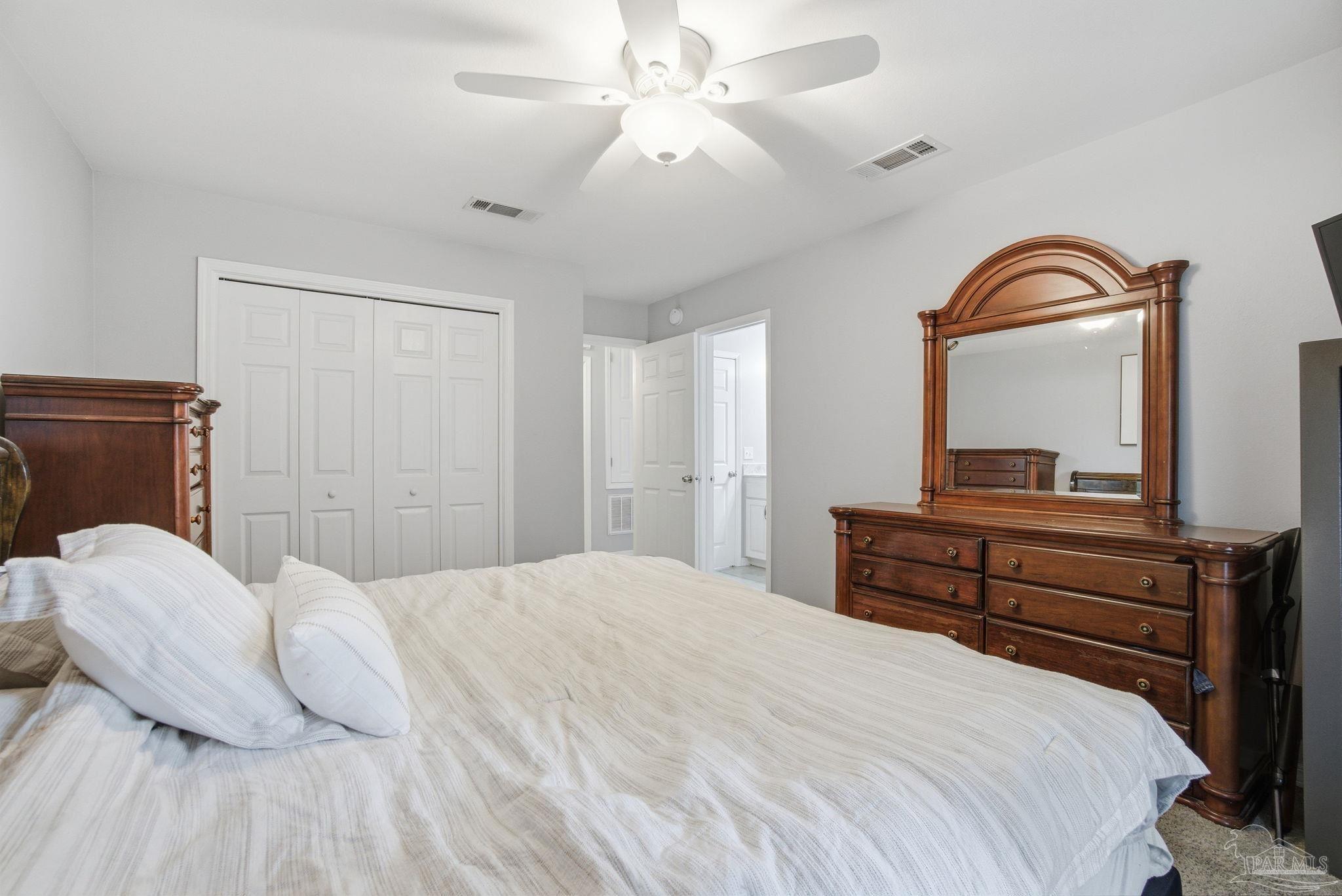 4393 Rice Road Milton, FL 32583 - Photo 18 of 52 a bedroom with a bed and a dresser