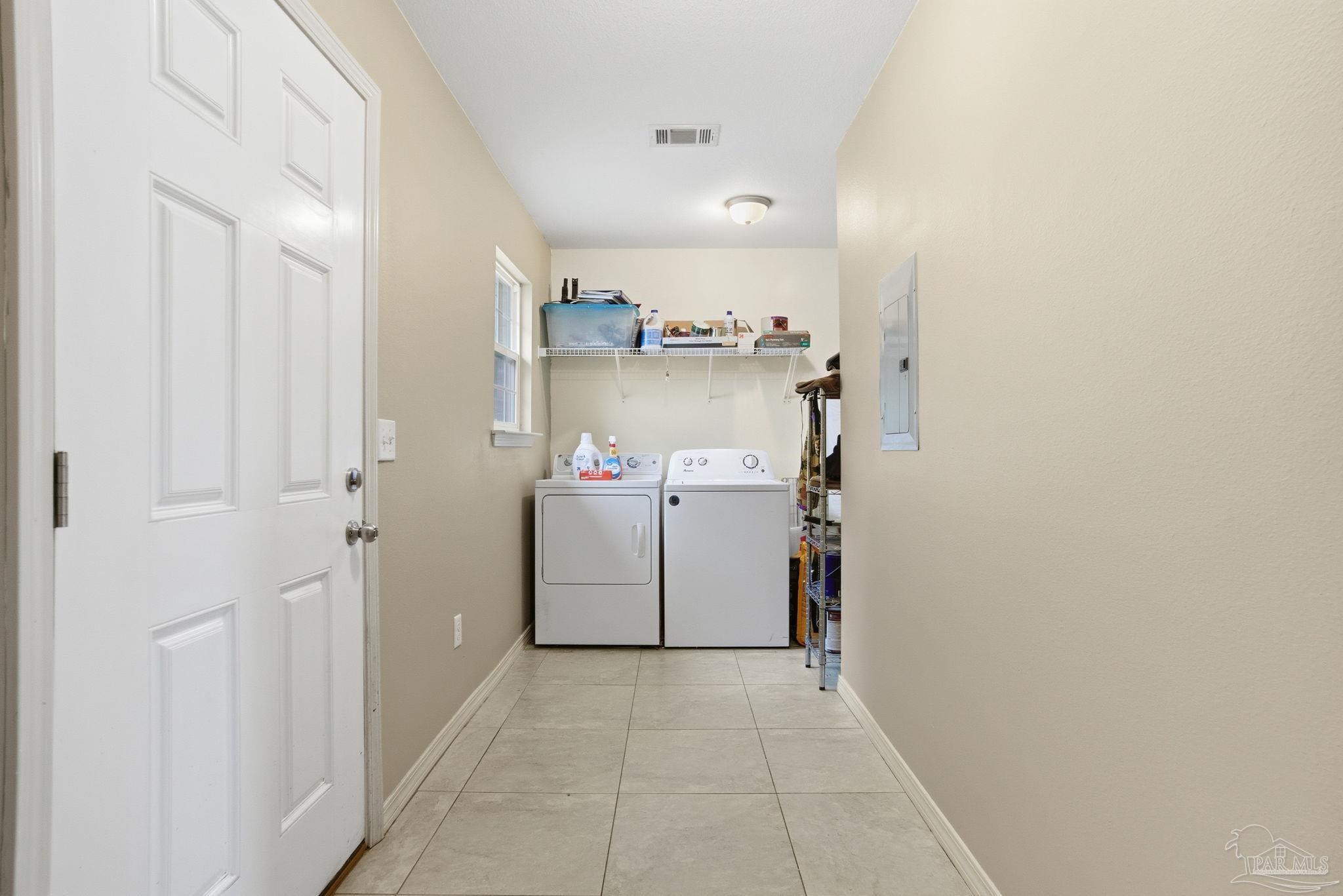 4393 Rice Road Milton, FL 32583 - Photo 22 of 52 a utility room with cabinets washer and dryer
