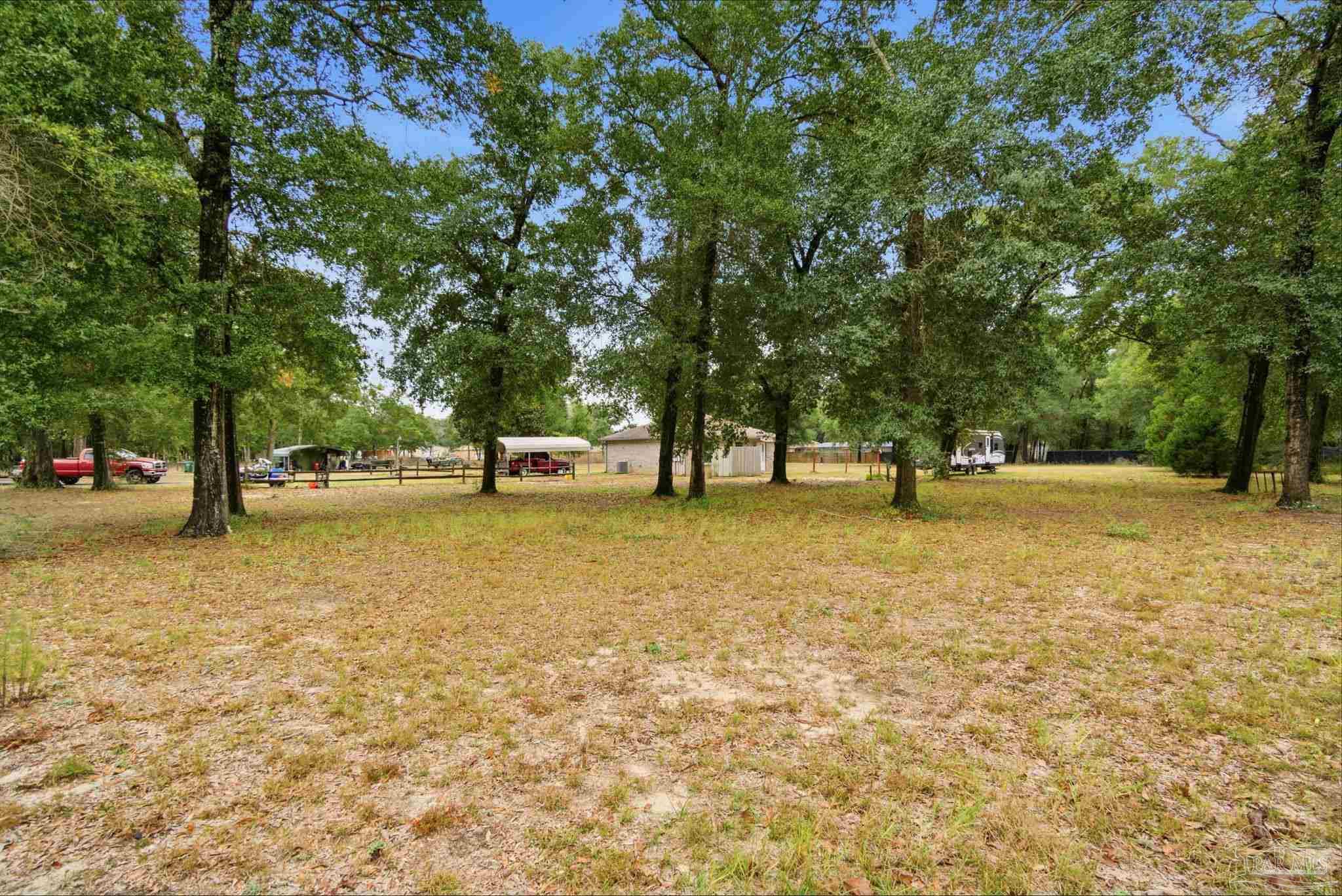4393 Rice Road Milton, FL 32583 - Photo 25 of 52 a view of outdoor space with trees
