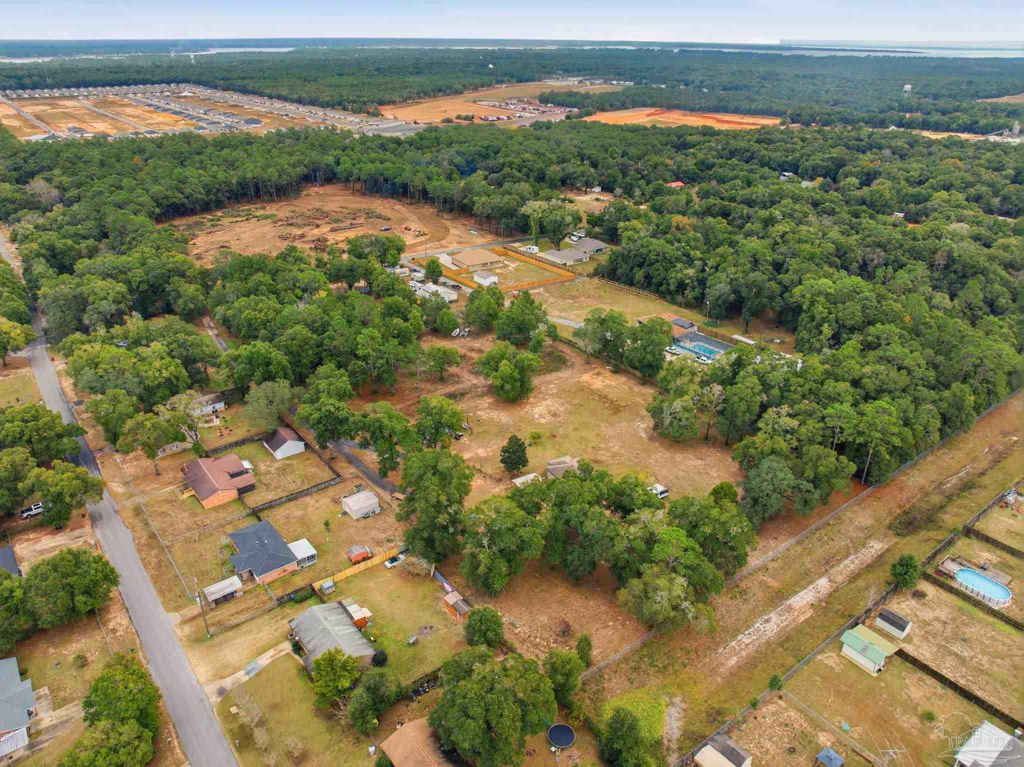 4393 Rice Road Milton, FL 32583 - Photo 38 of 52 an aerial view of residential houses with outdoor space and river