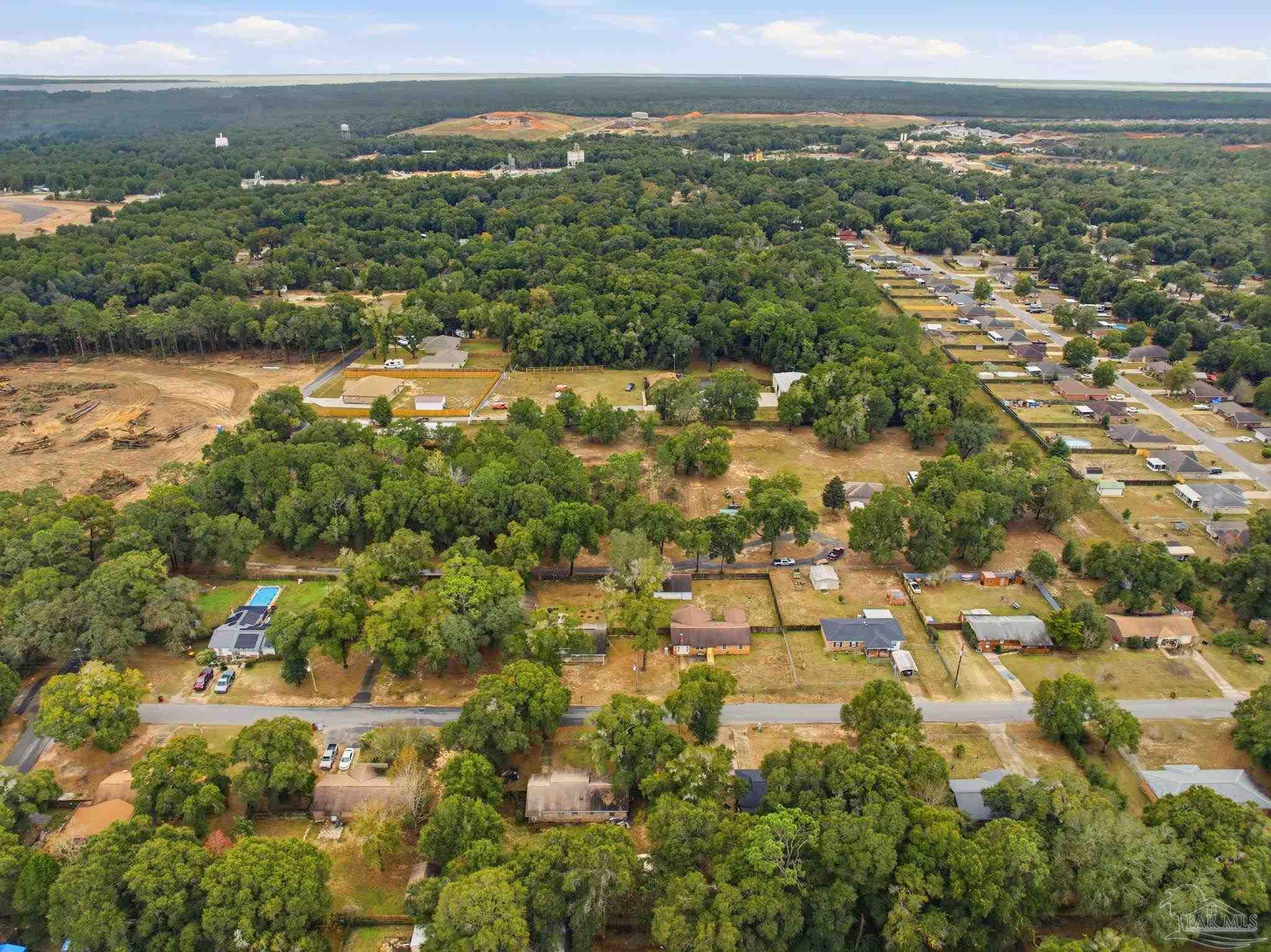 4393 Rice Road Milton, FL 32583 - Photo 40 of 52 an aerial view of residential houses with outdoor space and trees