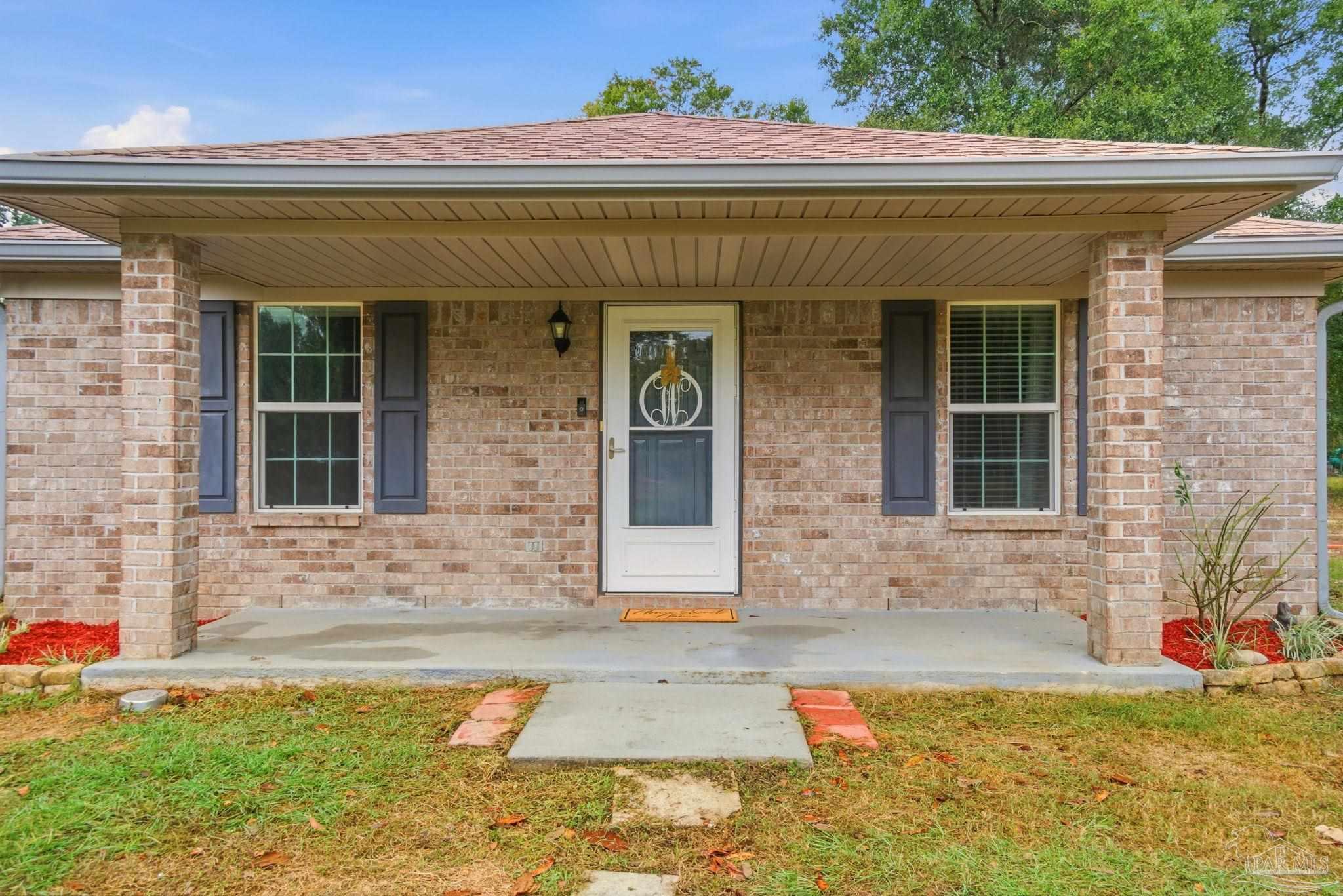 4393 Rice Road Milton, FL 32583 - Photo 5 of 52 a front view of a house with a yard