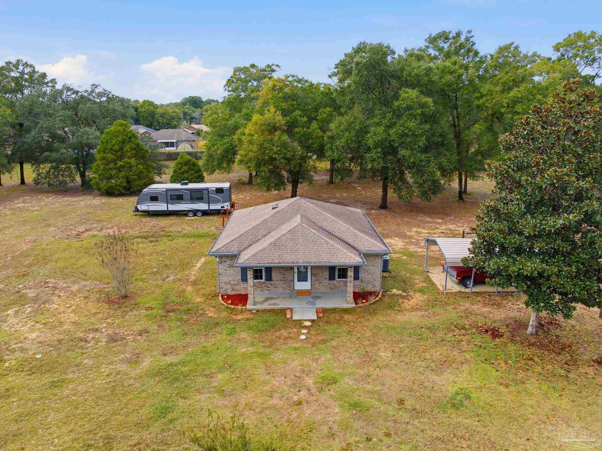 4393 Rice Road Milton, FL 32583 - Photo 51 of 52 a view of a house with swimming pool and sitting area