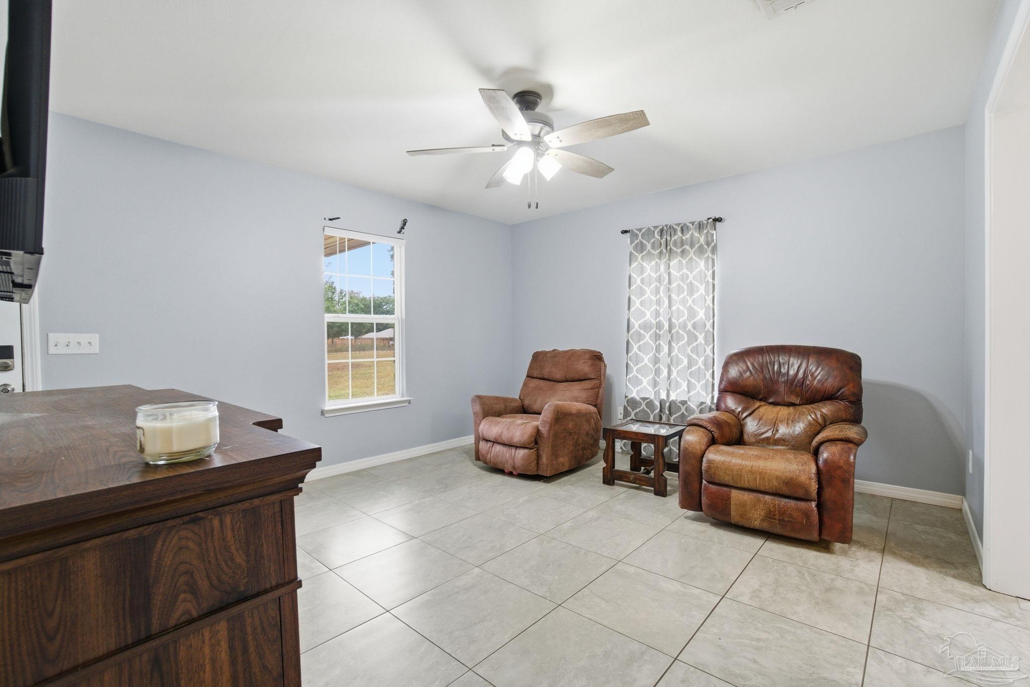4393 Rice Road Milton, FL 32583 - Photo 10 of 52 a living room with furniture and a window