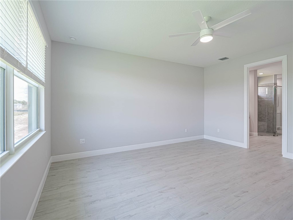 6422 High Pointe W Way Vero Beach, FL 32967 - Photo 12 of 33 an empty room with windows and fan