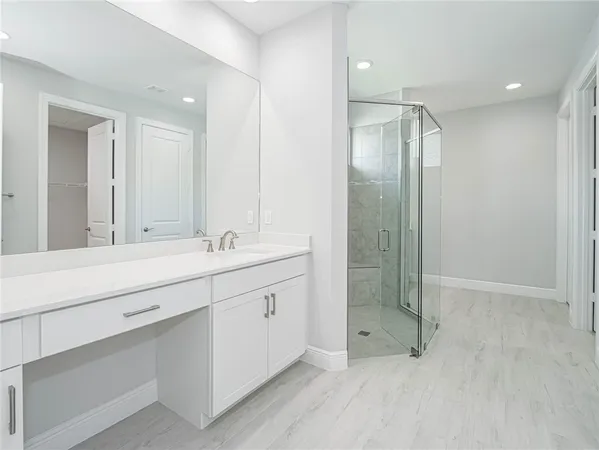 a bathroom with a double vanity sink mirror and shower